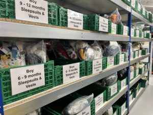 MammaKind's shelves in their warehouse, showing the essential items they have ready to give to families.