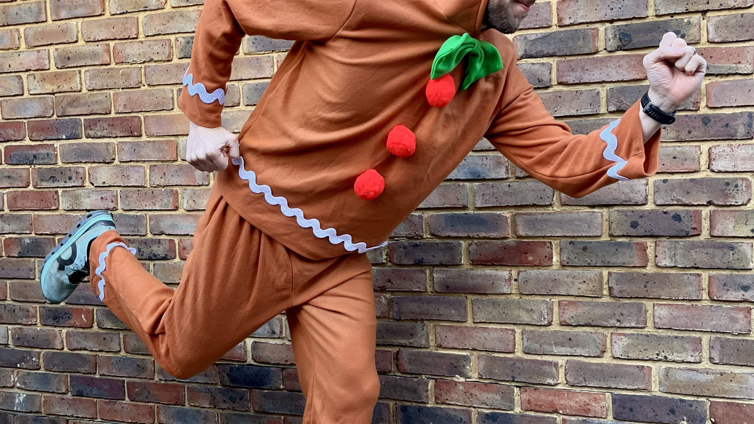 Ralph posing in a gingerbread man suit