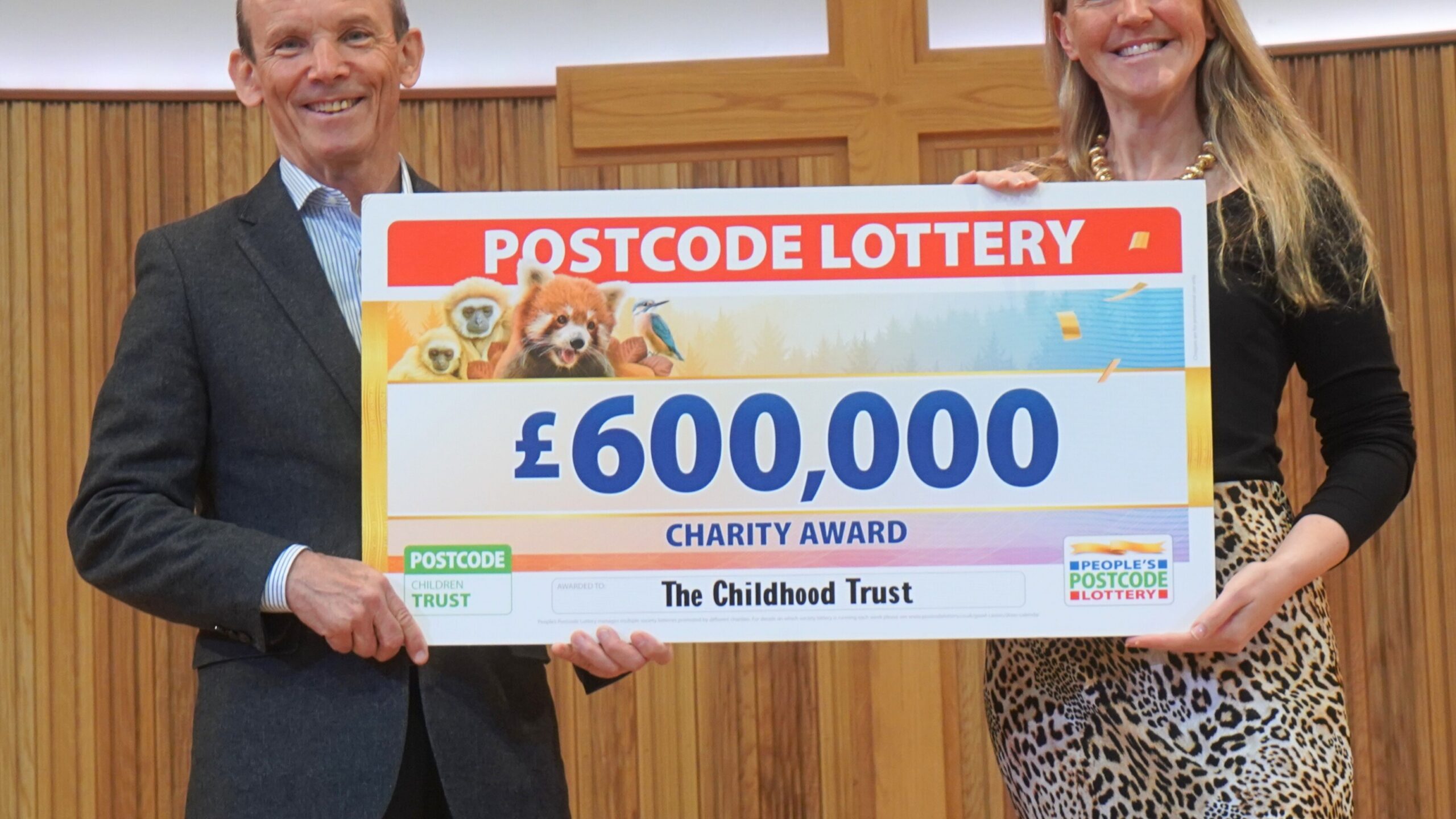 Grant Gordon receiving a cheque from The Postcode Lottery