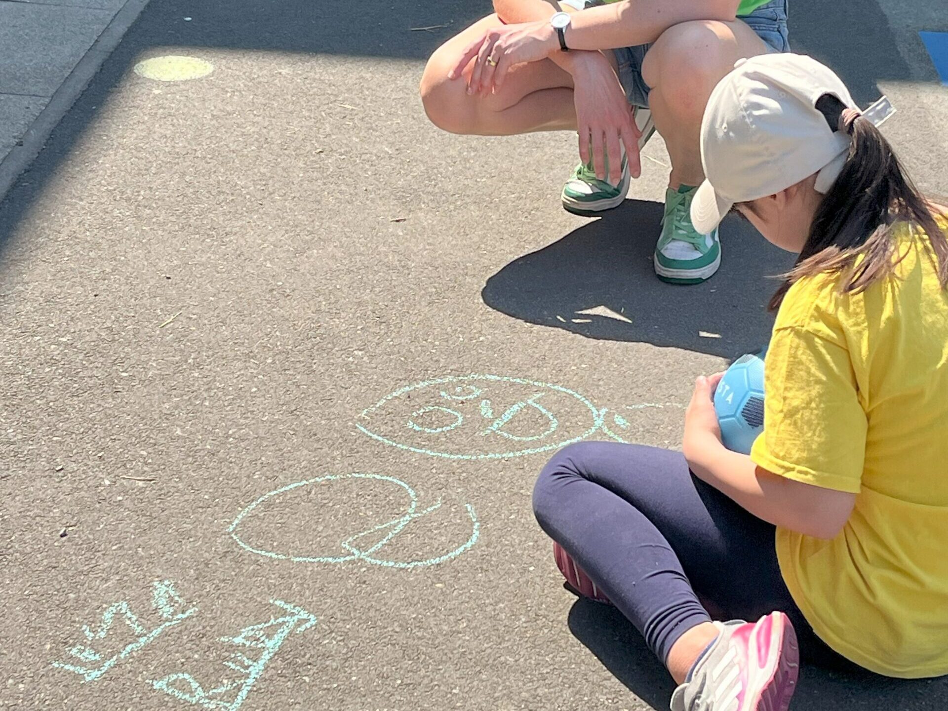 Child drawing on floor with chalk