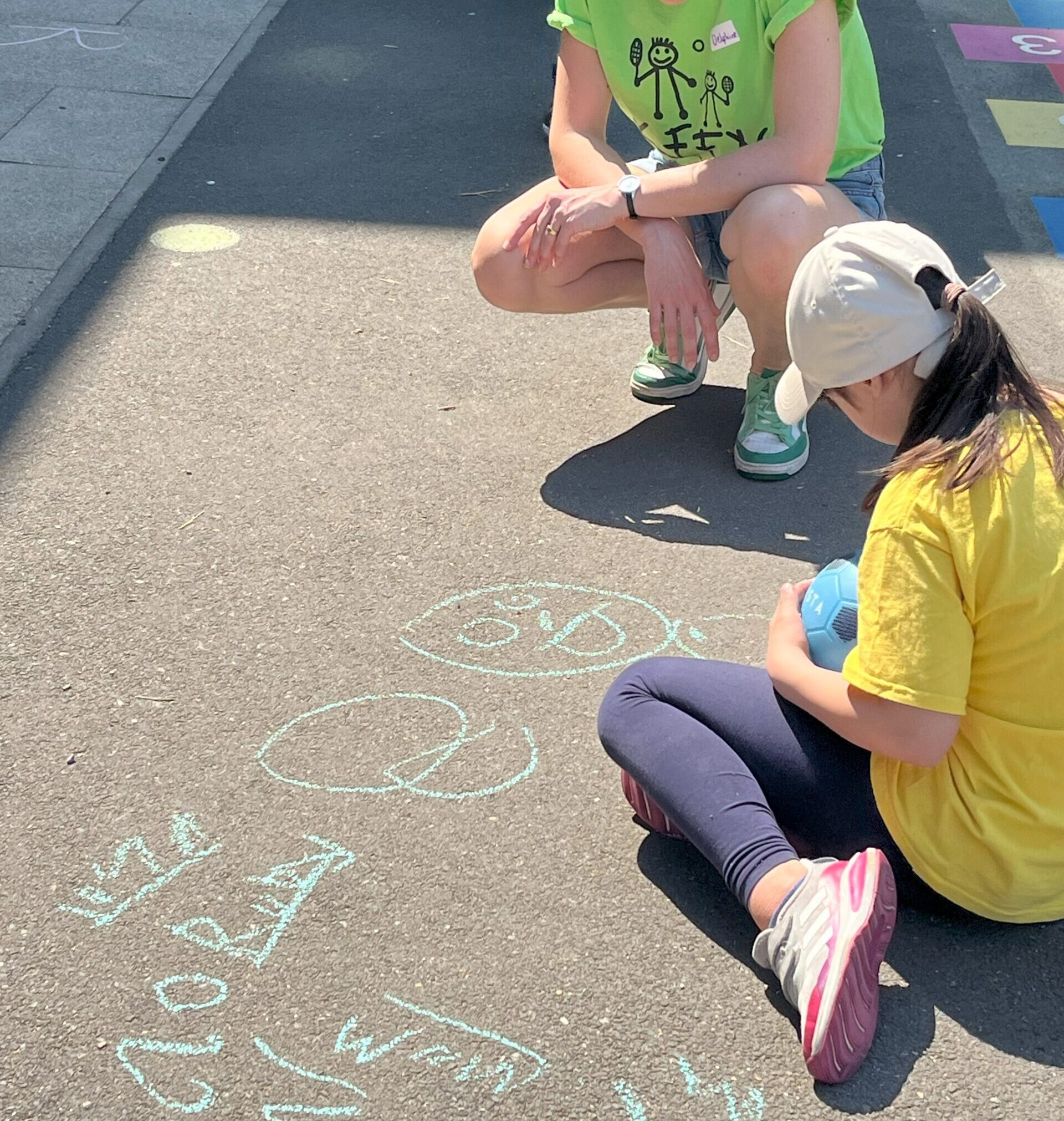 Child drawing on floor with chalk